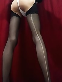 A sissy with her butt plugged and wearing a thong.